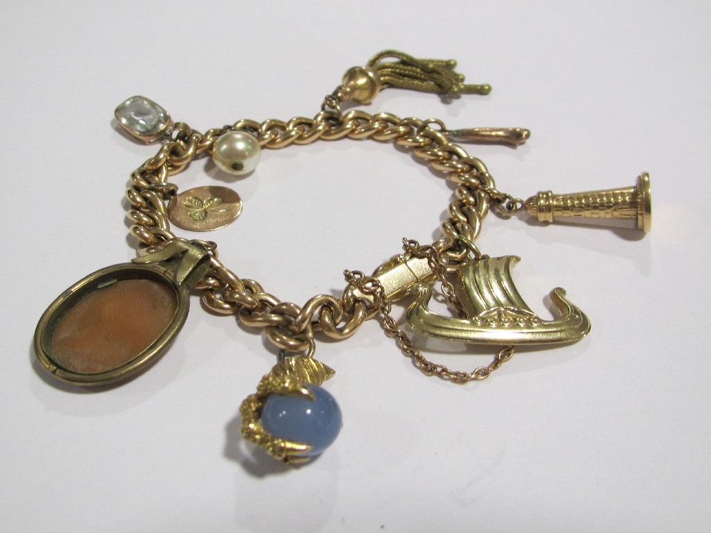 Appraisal: Yellow metal curb link charm bracelet with various charms to