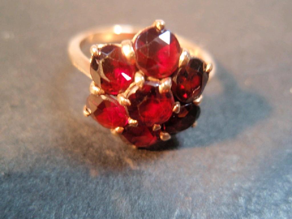 Appraisal: A floral form garnet set ct gold dress ring