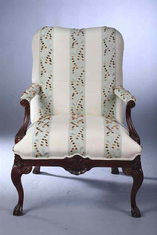 Appraisal: CHIPPENDALE STYLE CARVED MAHOGANY OPEN-ARM CHAIR Tight back stuff-over seat