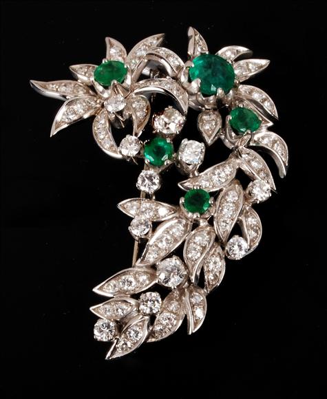 Appraisal: A emerald and diamond brooch of floral and foliate spray