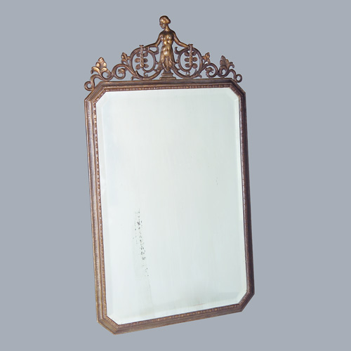 Appraisal: OSCAR BACH Wall-hanging mirror with clip-corner frame topped by foliate