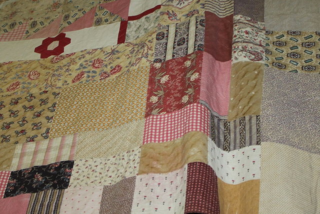 Appraisal: A LARGE PATCHWORK QUILT the central panel having a design