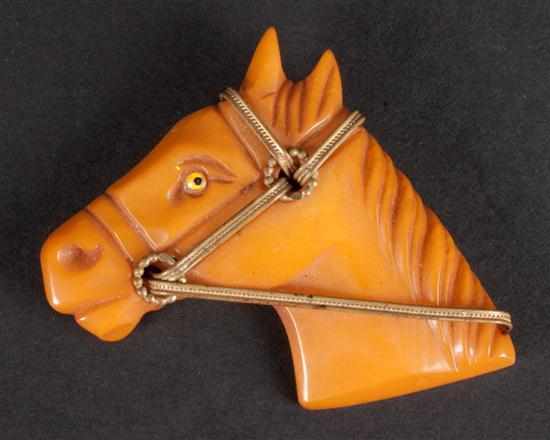 Appraisal: Bakelite and gilt metal horse-head brooch Estimate - Any condition