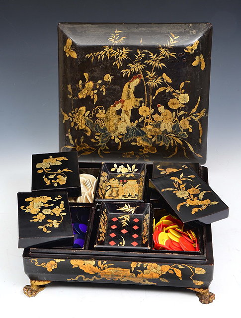 Appraisal: A CHINESE BLACK AND GOLD LACQUER RECTANGULAR GAMES BOX the