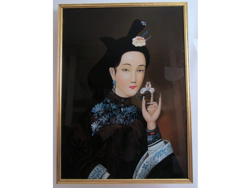 Appraisal: A Chinese reverse painted portrait of a beauty holding a