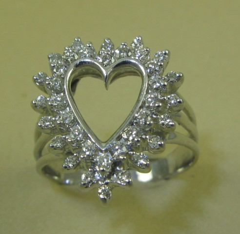 Appraisal: DIAMOND AND FOURTEEN KARAT GOLD RING The white gold heart