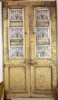 Appraisal: Pair weathered carved entry doors with iron panels Pair of