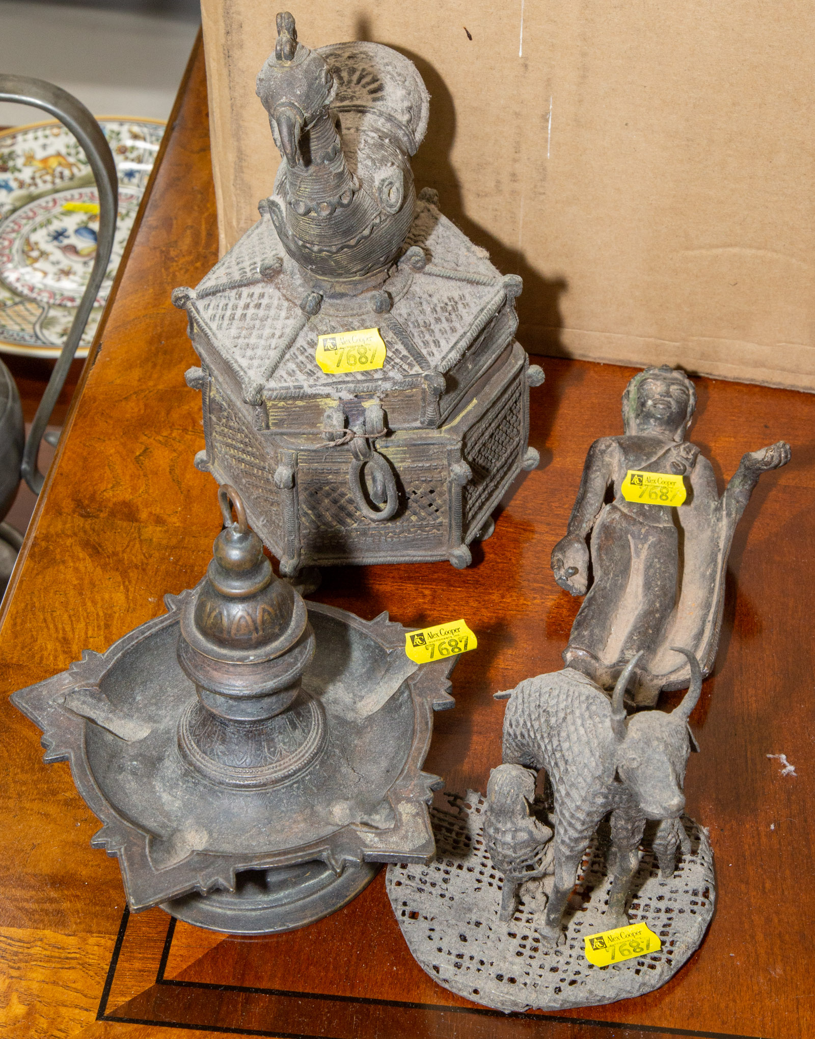 Appraisal: FOUR PRIMITIVE INDIAN BRONZE ARTICLES Including a bronze oil lamp