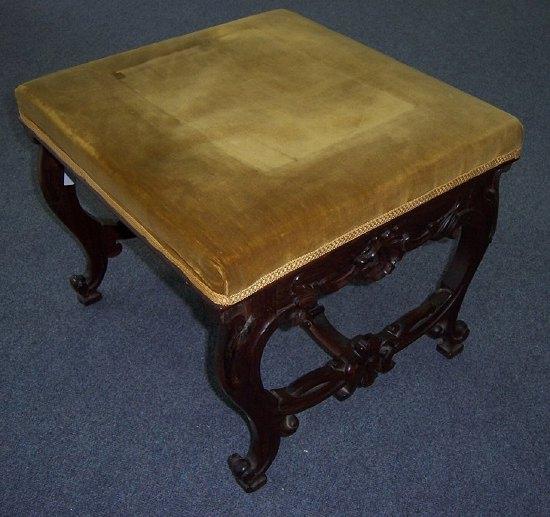 Appraisal: A Victorian rosewood stool the square upholstered top on carved