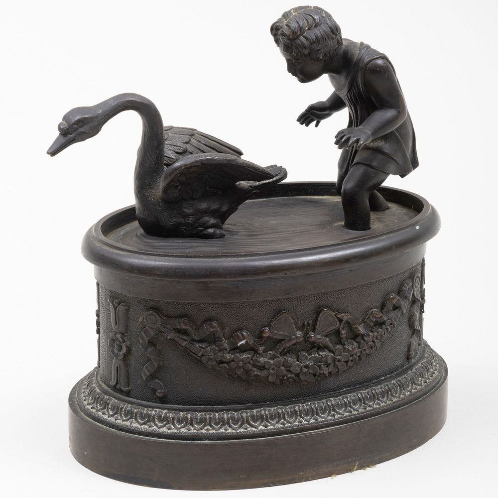 Appraisal: Patinated Metal Inkwell of a Child Chasing a Swan The