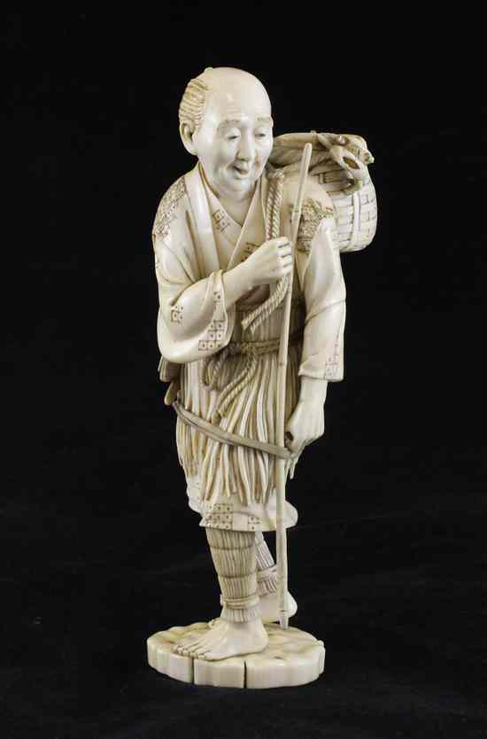 Appraisal: A fine Japanese ivory figure of a standing fisherman Meiji