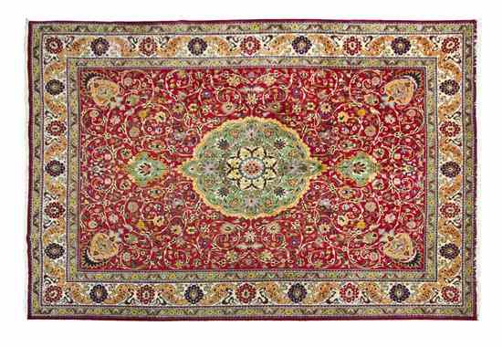 Appraisal: A Persian Tabriz Rug having a foliate center medallion surrounded