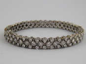 Appraisal: A white metal tests carat gold diamond bangle set with