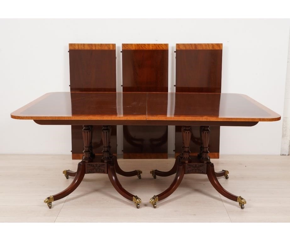 Appraisal: Baker furniture banded mahogany dining table with quad-leg pedestal base