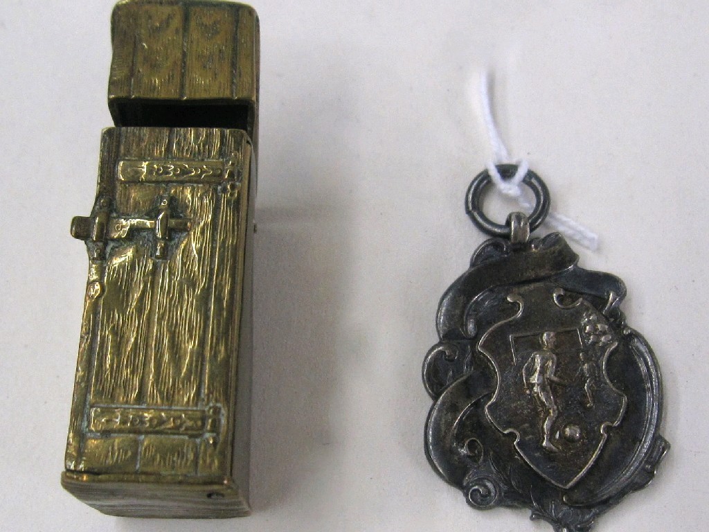 Appraisal: Lot comprising silver football medal and a brass vesta modelled