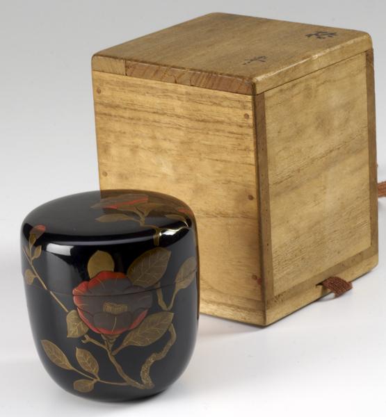 Appraisal: JAPANESE LACQUER Black lacquer tea caddy with camellia decoration Meiji