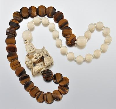 Appraisal: An Impressive Ivory and Tiger Eye Necklace The necklace is