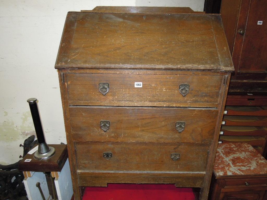 Appraisal: An Edwardian oak bureau the fall front enclosing a simply