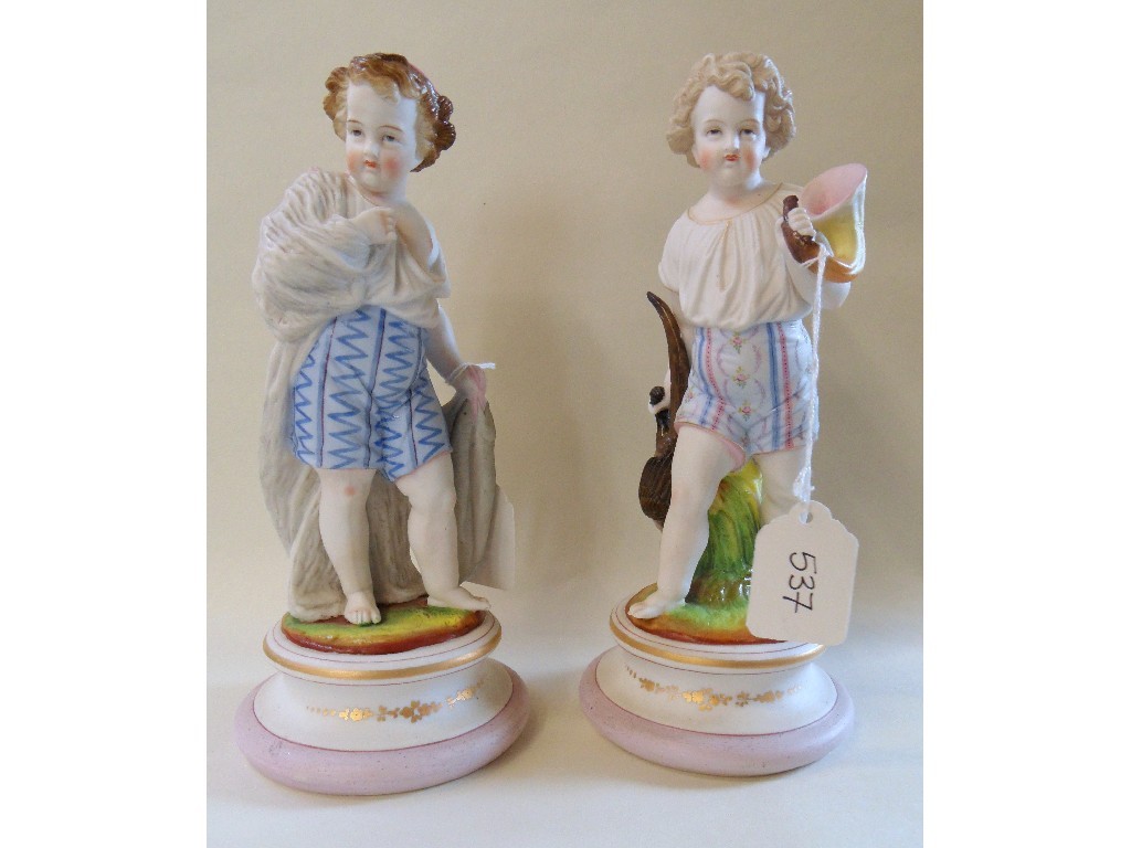 Appraisal: Pair of bisque figures of young boys one carrying fish