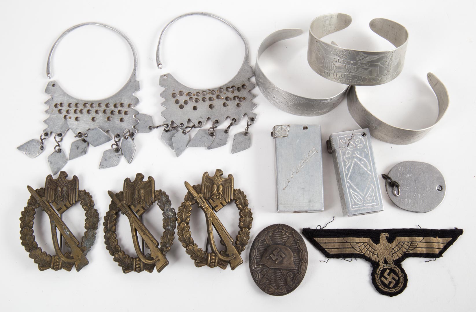 Appraisal: Bag of WWII aluminum trench art German badges and a