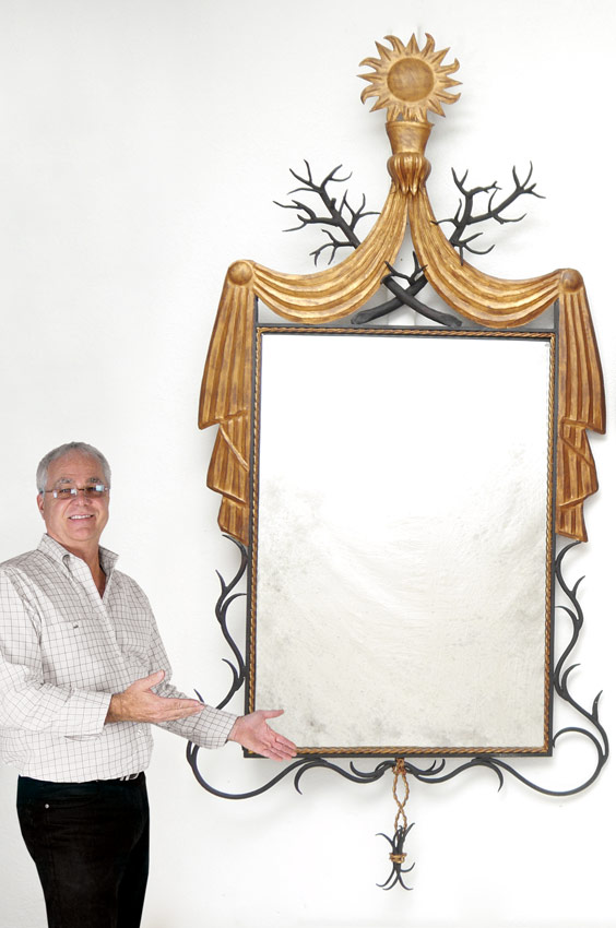 Appraisal: PAINT DECORATED METAL FRAMED WALL MIRROR Frame featuring the sun