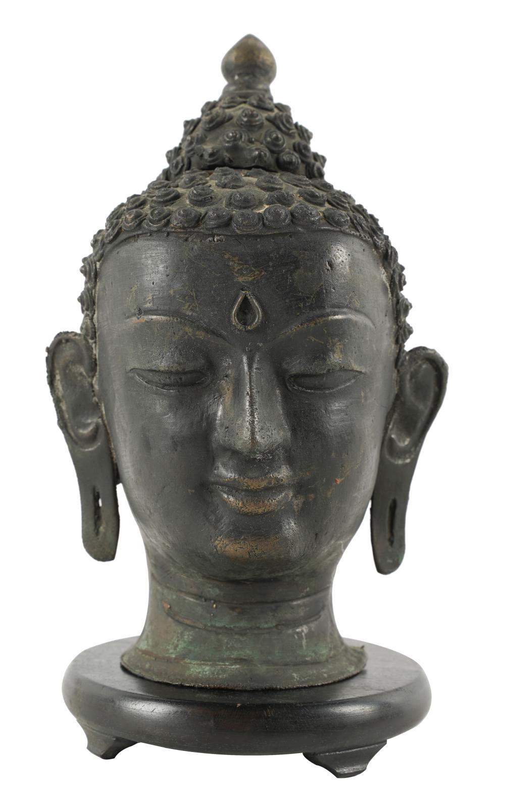 Appraisal: BRONZE HEAD OF BUDDHAwith later wooden base Provenance The Estate