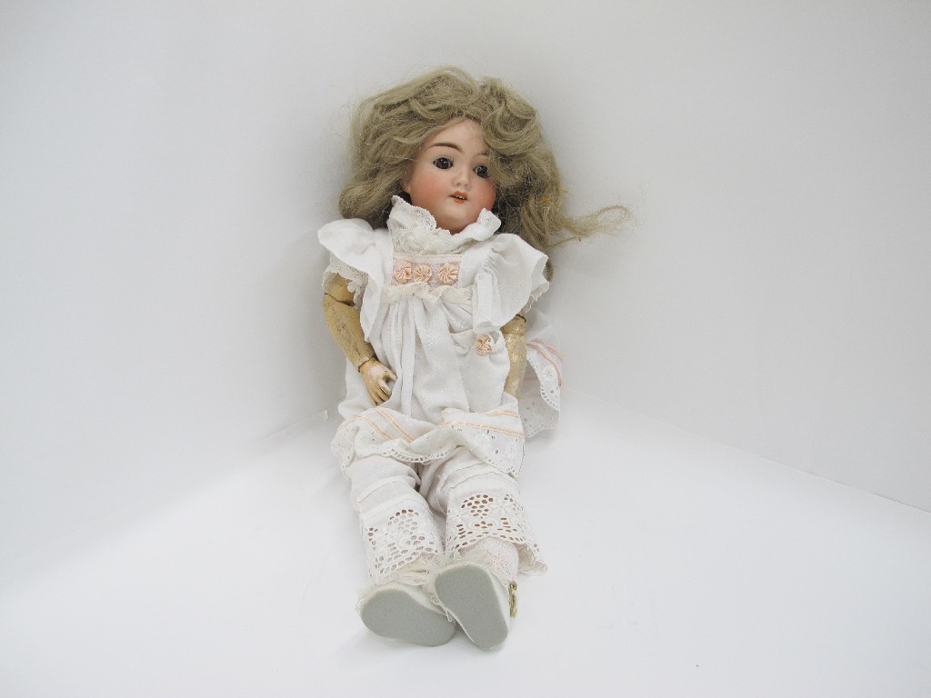 Appraisal: A porcelain headed girl doll with articulated composition body