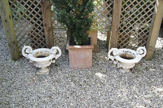 Appraisal: Pair of Victorian small wrought iron campana urnson square bases