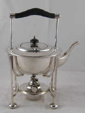 Appraisal: A silver plated kettle on stand with lamp in the