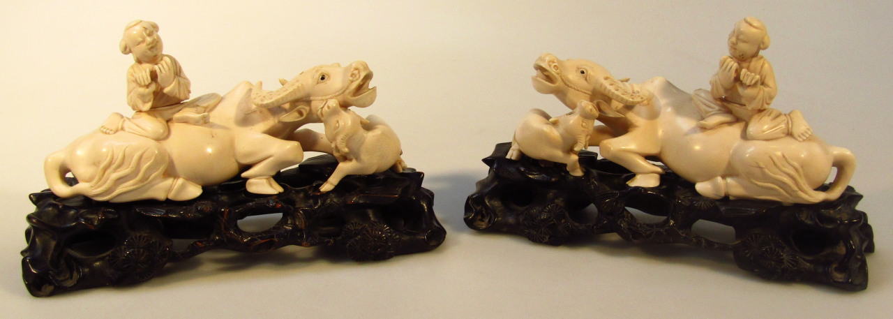 Appraisal: A pair of Chinese figures of children riding water buffalo