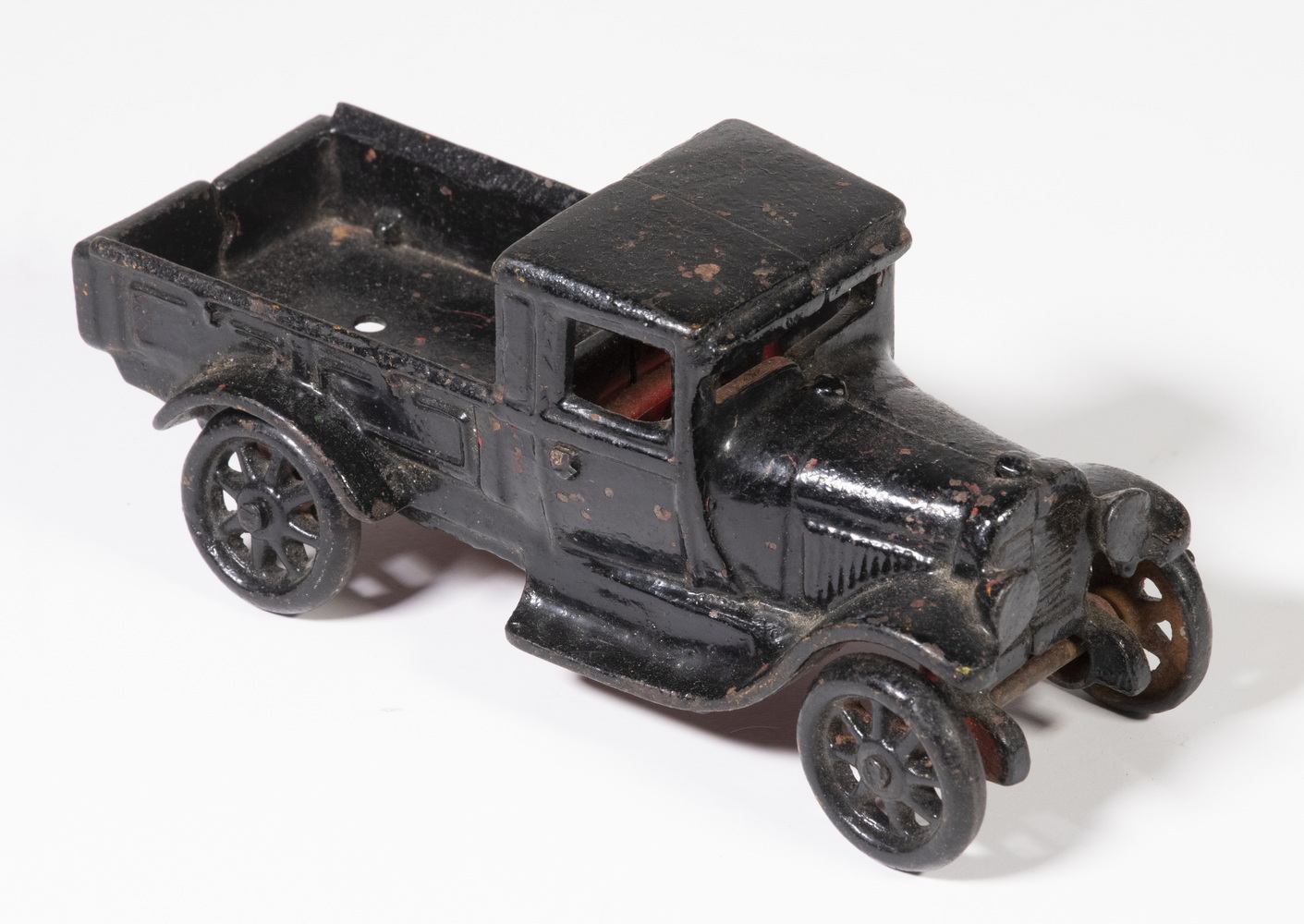 Appraisal: CAST IRON ARCADE PICKUP TRUCK Circa black over red painted