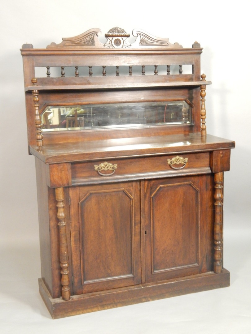 Appraisal: A Victorian walnut chiffioner the raised back with spindle turned