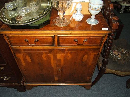 Appraisal: A yew wood veneered side cabinet the two short drawers