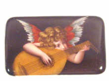 Appraisal: A hand painted procelain plaque depicting a cherub playing a