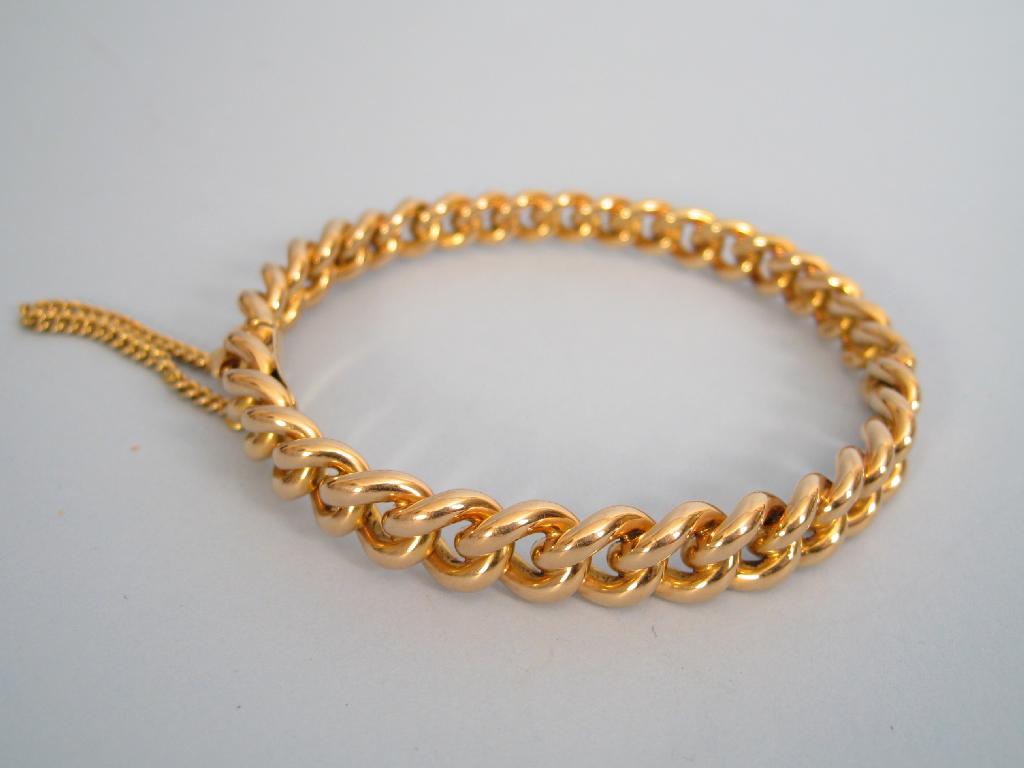 Appraisal: An ct gold rigid curb-link Bracelet with safety chain approx