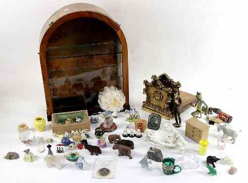 Appraisal: A small glazed cabinet a collection of trinkets including carved