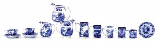 Appraisal: Collection of flow blue cups saucers and pitchers Set of