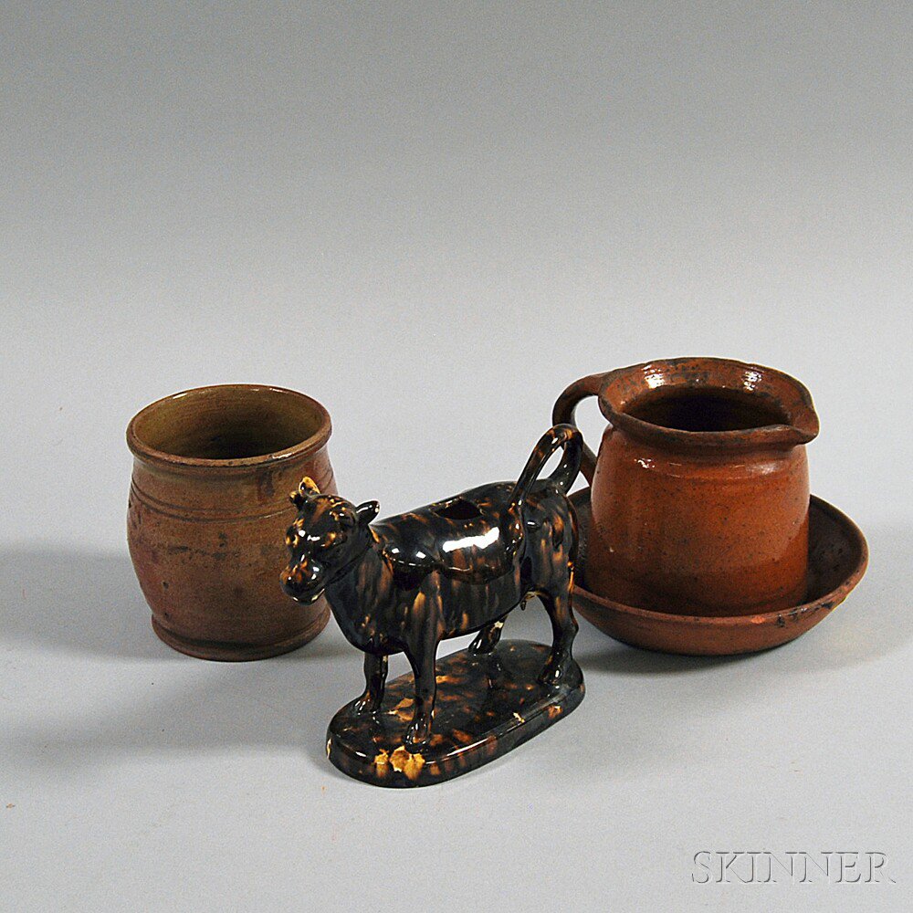 Appraisal: Four Pottery Items a Rockingham-glazed cow creamer and three redware