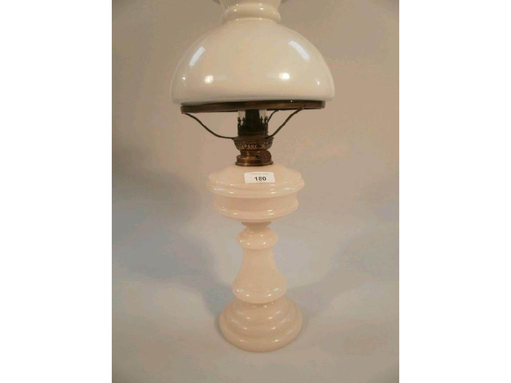 Appraisal: A Victorian oil lamp with integral white glass reservoir and