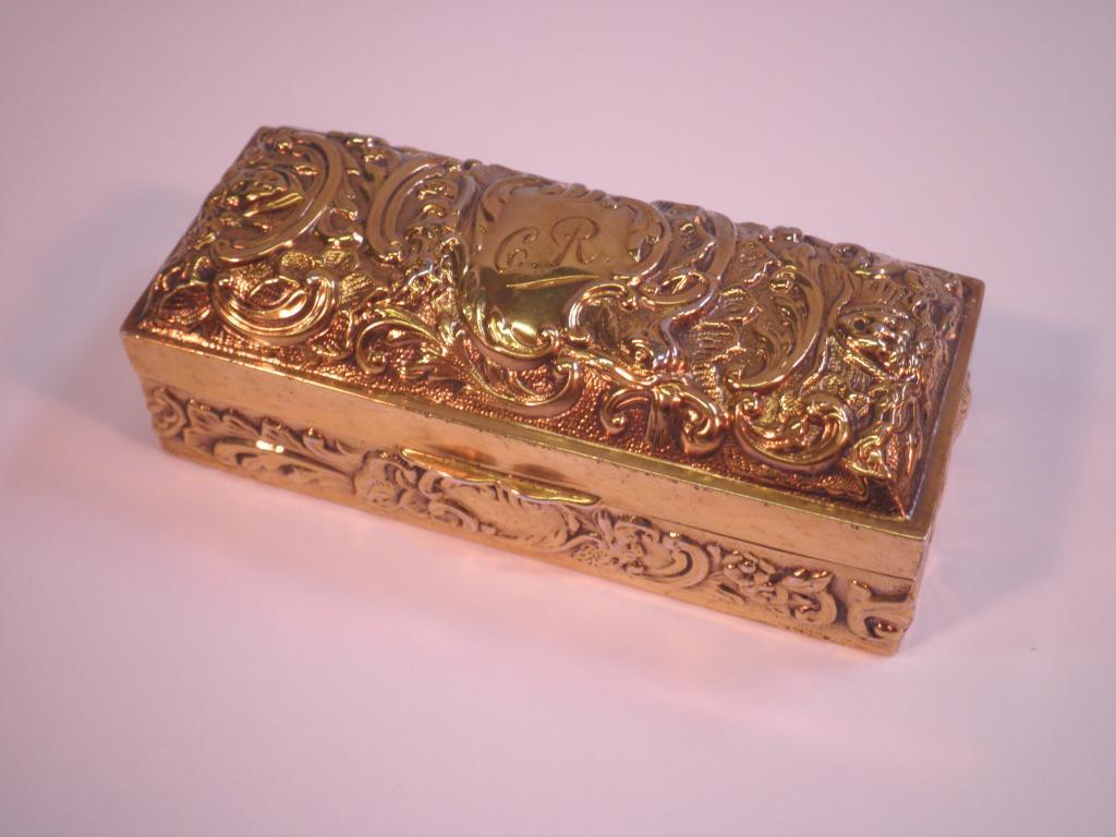 Appraisal: A rectangular gilt box and cover embossed with scrolls and