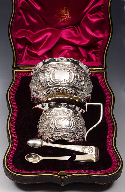 Appraisal: A CASED SILVER CREAM JUG AND BASIN with chased foliate