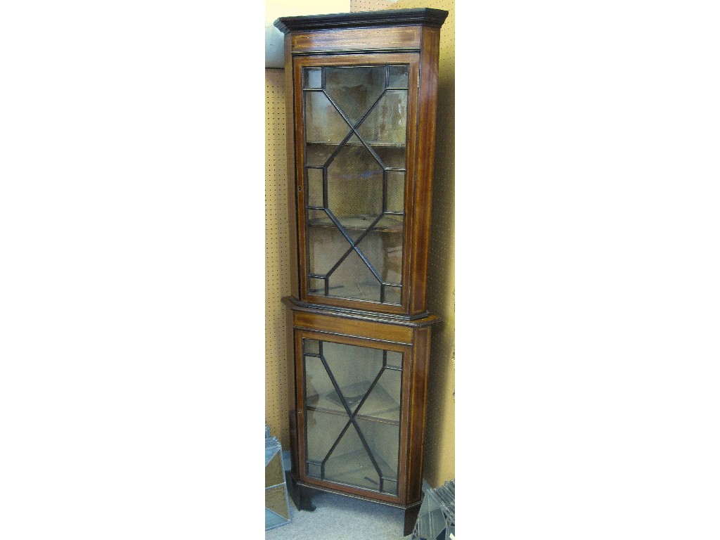 Appraisal: Edwardian mahogany and crossbanded astragal glazed corner cabinet in two