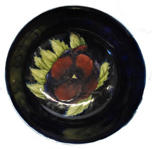 Appraisal: A William Moorcroft fruit bowl Pansy pattern impressed and painted