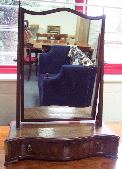 Appraisal: A mahogany swing frame toilet mirror with arch top plate