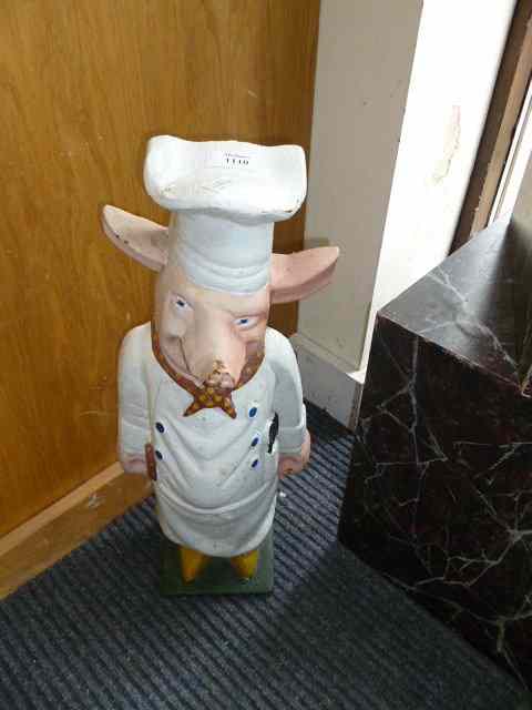 Appraisal: A CAST IRON PIG IN CHEFS UNIFORM high