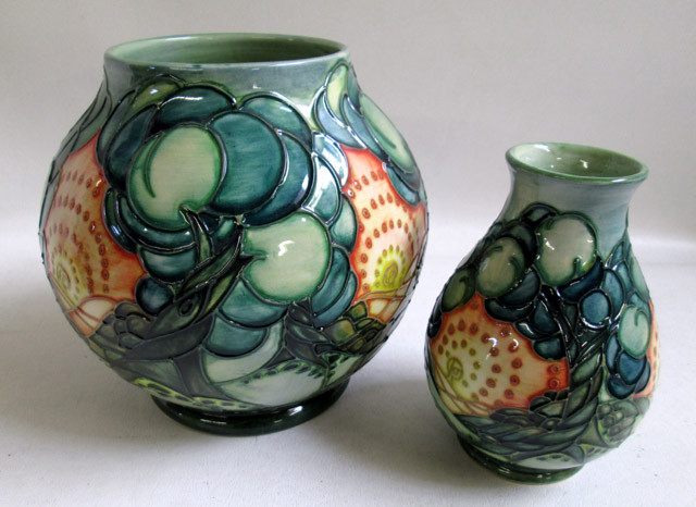 Appraisal: TWO MOORCROFT POTTERY VESSELS hand painted underglaze in a stylized