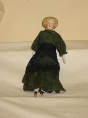 Appraisal: A china shoulder headed doll with painted face moulded hair