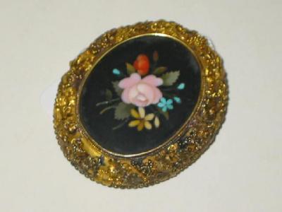 Appraisal: A PIETRA DURA BROOCH of oval form inlaid with a