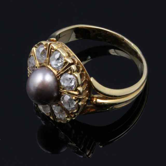 Appraisal: A black pearl and diamond cluster ring in a galleried