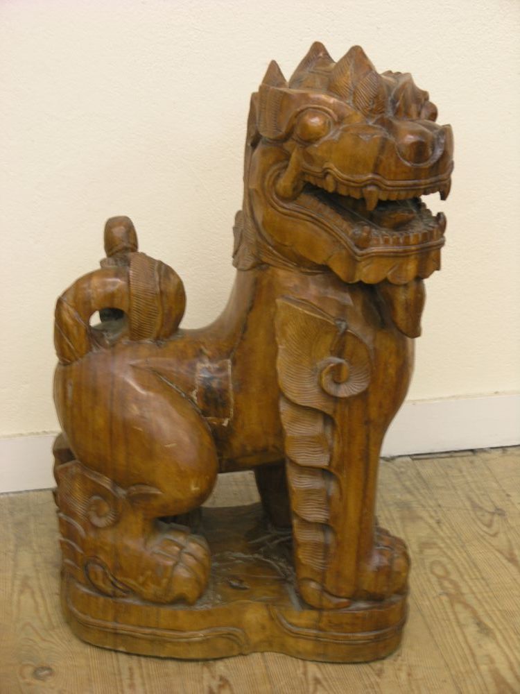 Appraisal: A pair of Chinese carved wood Kylin models each recumbent